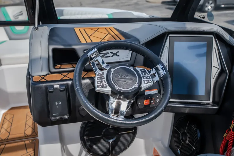 Slide: The Image of 2021 Tigé 21ZX boat dashboard with steering wheel and touchscreen display. - 20