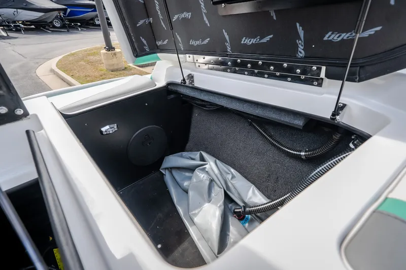 Slide: The Image of Open storage compartment in 2021 Tigé 21ZX boat, showcasing interior space and design. - 28