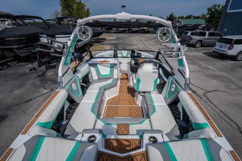 Slide: The Image of 2021 Tigé 21ZX boat interior with modern seating and sleek design in a marina setting. - 15