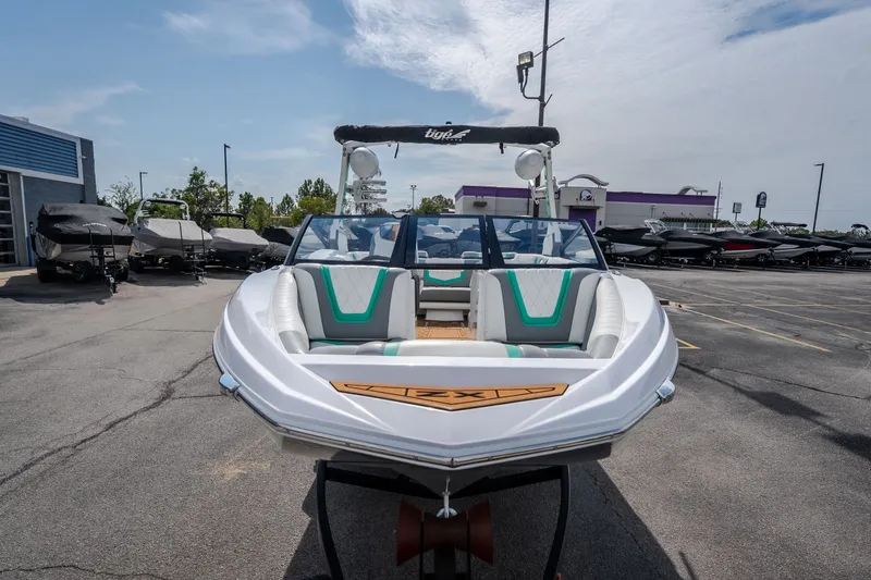 The Image of 2021 Tigé 21ZX boat in a dealership parking lot, front view. - 0