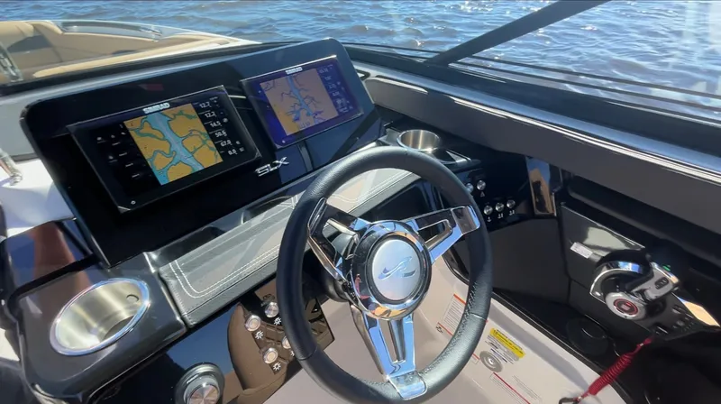 Slide: The Image of The image shows the helm of a Sea Ray SLX 260 Outboard with modern navigation systems. - 19