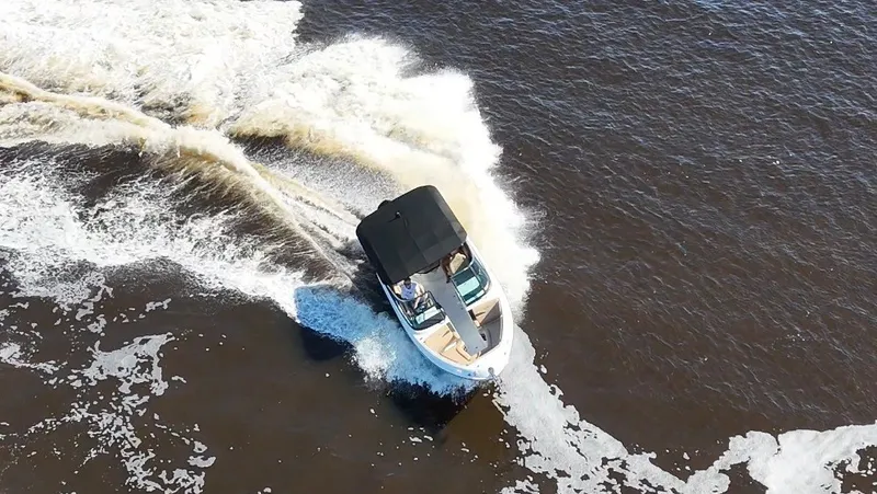 Slide: The Image of A 2027 Sea Ray SLX 260 Outboard speeds across the water, leaving a trail of splashing wake. - 22