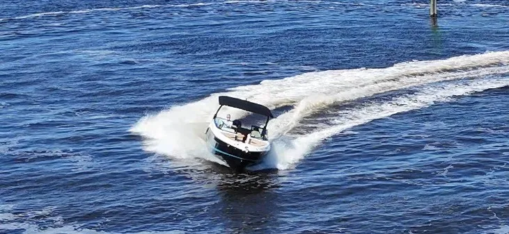 Slide: The Image of A 2027 Sea Ray SLX 260 Outboard speeding across the water. - 23