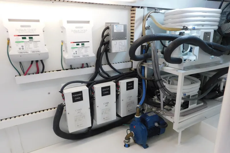Slide: The Image of Engine room of a 1996 Viking 50 Convertible yacht with electrical and plumbing systems. - 71