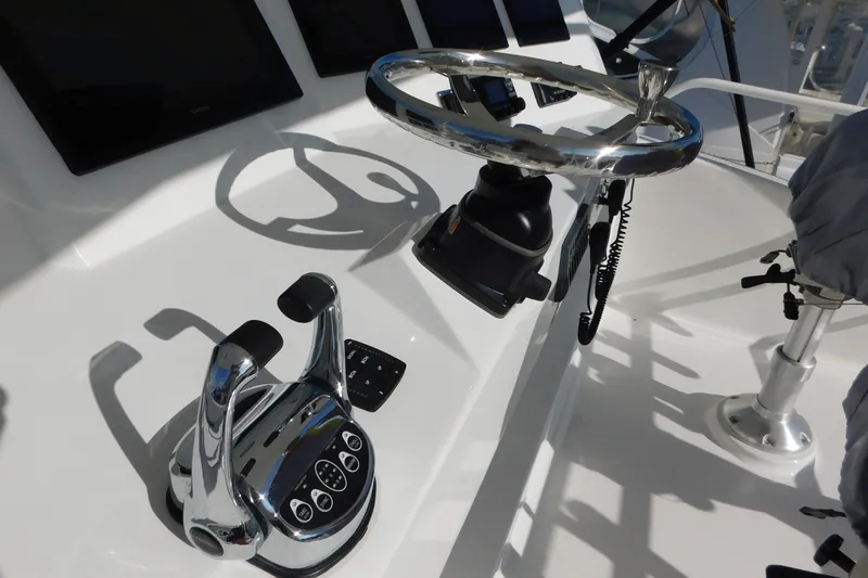 Slide: The Image of Control panel of a 1996 Viking 50 Convertible yacht with steering wheel and throttle. - 13