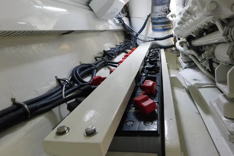 Slide: The Image of Engine room of a 1996 Viking 50 Convertible boat, showcasing battery setup and wiring. - 74