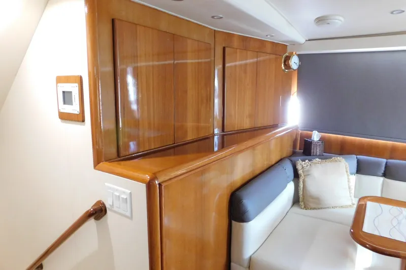 Slide: The Image of Interior of 1996 Viking 50 Convertible yacht with wood paneling and cushioned seating. - 29
