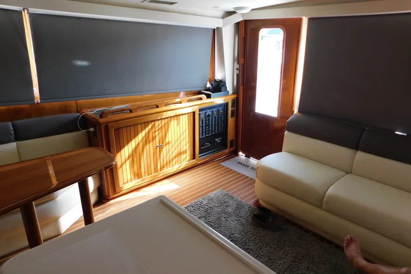 Slide: The Image of Interior of a 1996 Viking 50 Convertible yacht with wood accents and comfortable seating. - 24
