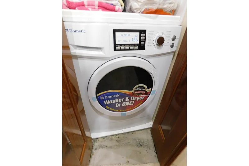 Slide: The Image of Dometic washer and dryer combo in a 1996 Viking 50 Convertible yacht. - 49