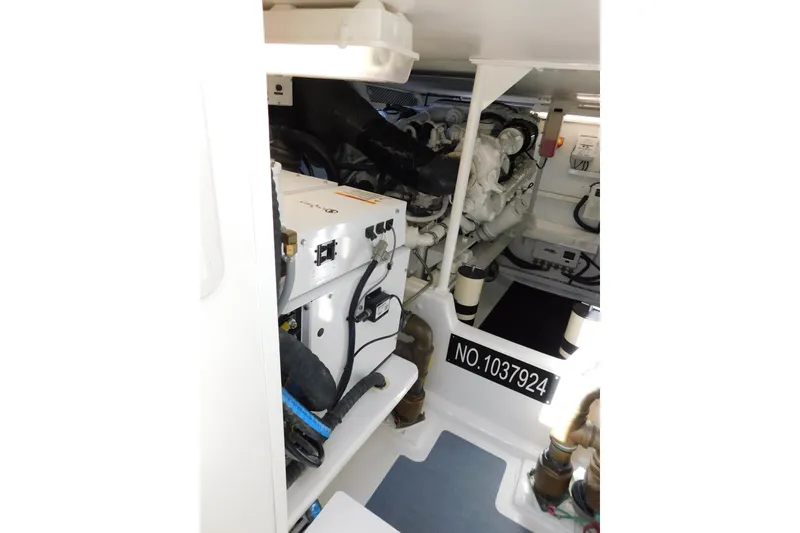 Slide: The Image of Engine room of a 1996 Viking 50 Convertible yacht, showcasing mechanical components. - 61