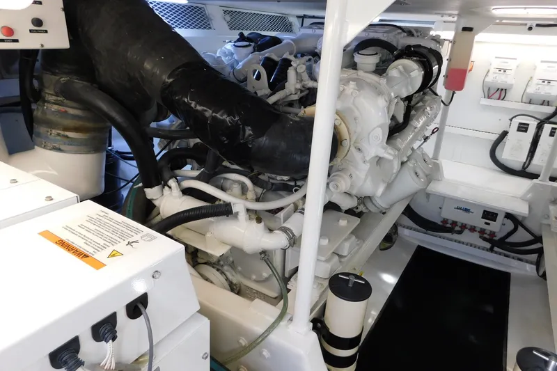 Slide: The Image of Engine room of a 1996 Viking 50 Convertible yacht, showcasing mechanical components. - 64