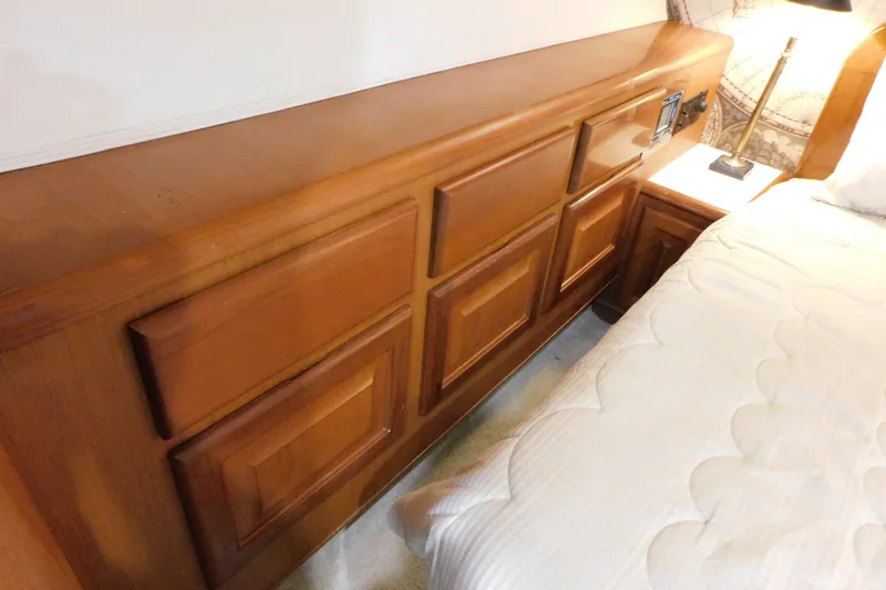 Slide: The Image of Wooden cabinetry beside bed in 1996 Viking 50 Convertible yacht interior. - 54