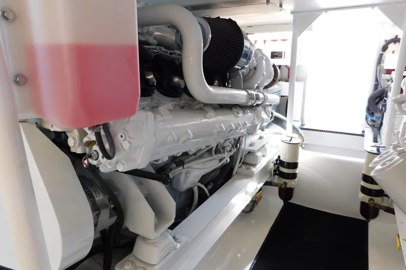 Slide: The Image of Engine room of a 1996 Viking 50 Convertible yacht, showcasing a clean, well-maintained engine. - 66