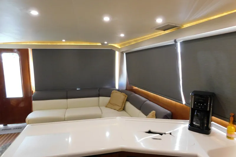 Slide: The Image of Luxurious interior of a 1996 Viking 50 Convertible yacht with modern seating and coffee maker. - 34
