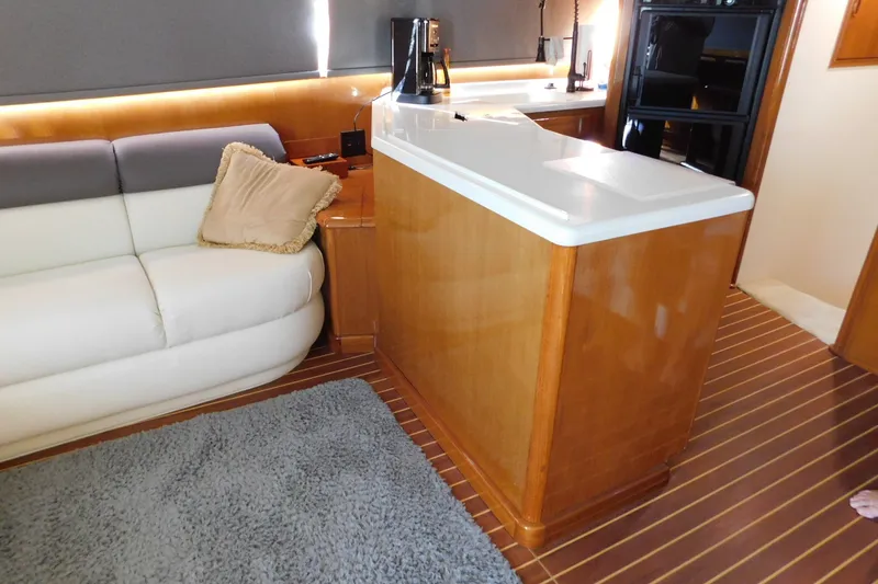 Slide: The Image of Interior of a 1996 Viking 50 Convertible yacht with modern furnishings and wooden flooring. - 31