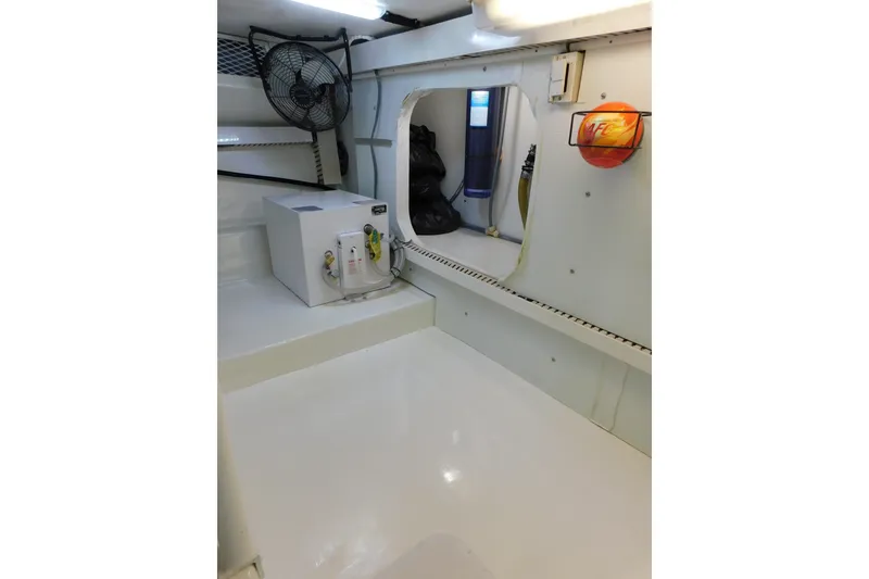 Slide: The Image of Engine room of 1996 Viking 50 Convertible yacht, featuring equipment and storage. - 76