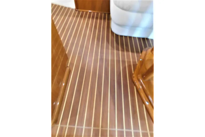 Slide: The Image of Teak flooring inside a 1996 Viking 50 Convertible yacht, showcasing elegant wood finish. - 37