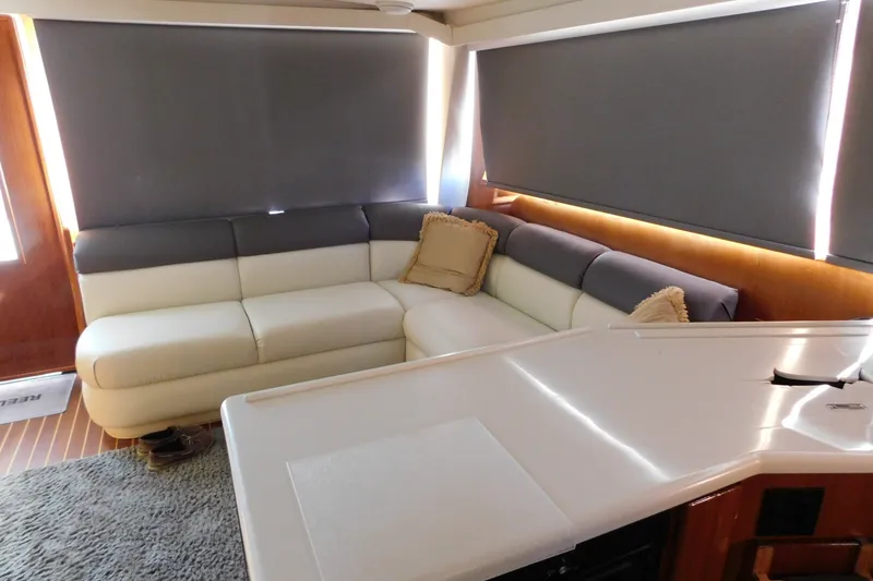 Slide: The Image of Interior of 1996 Viking 50 Convertible yacht with modern seating and blinds. - 25