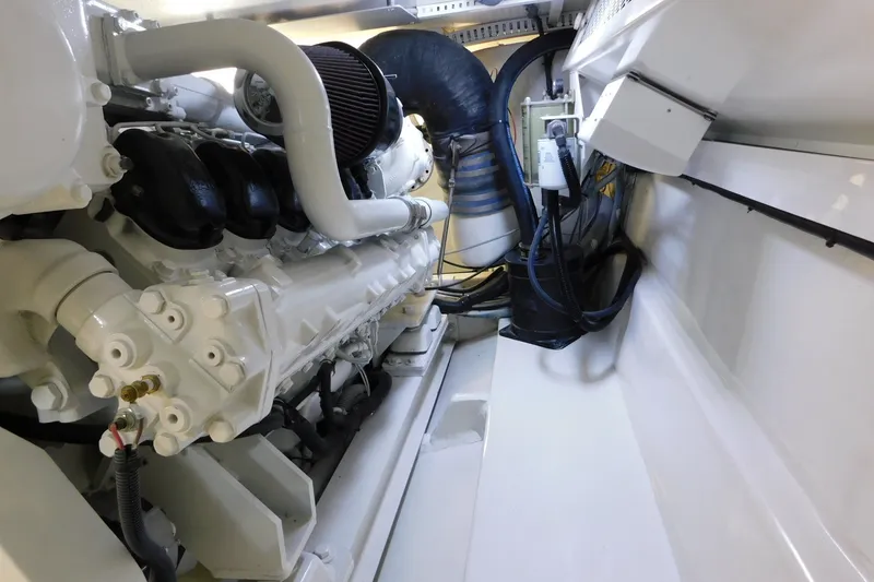 Slide: The Image of Engine room of a 1996 Viking 50 Convertible yacht, showcasing mechanical components. - 65