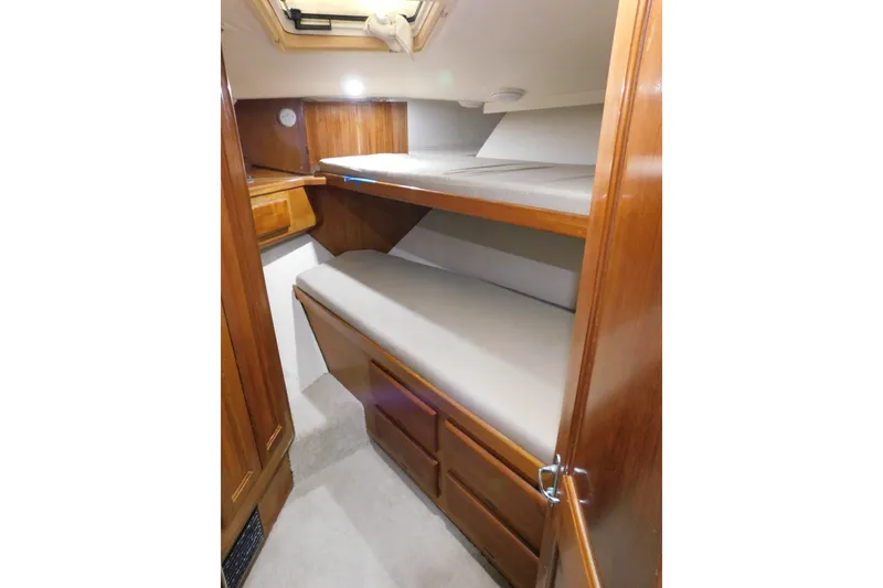 Slide: The Image of Interior cabin of 1996 Viking 50 Convertible yacht with wooden bunk beds. - 44