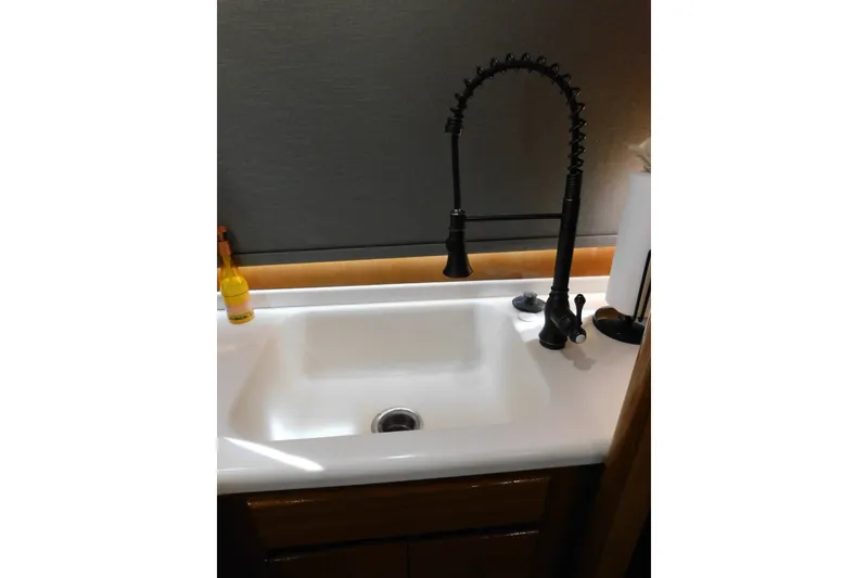 Slide: The Image of Modern kitchen sink with black faucet on Viking 50 Convertible, 1996 model. - 39