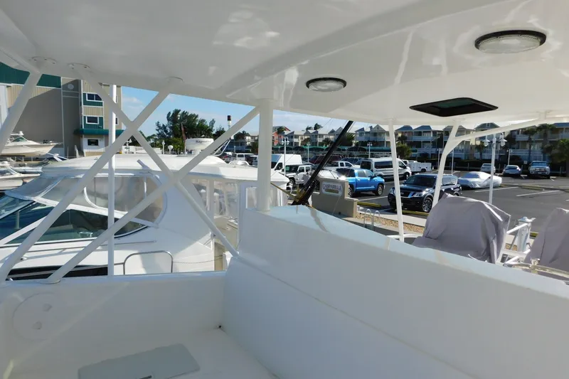 Slide: The Image of 1996 Viking 50 Convertible yacht docked at marina with covered seating area. - 9