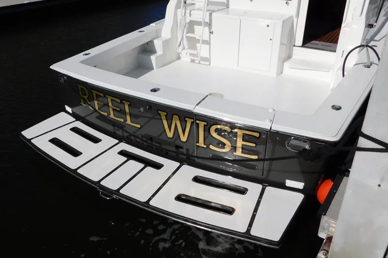 Slide: The Image of 1996 Viking 50 Convertible yacht named "Reel Wise" docked at marina. - 5