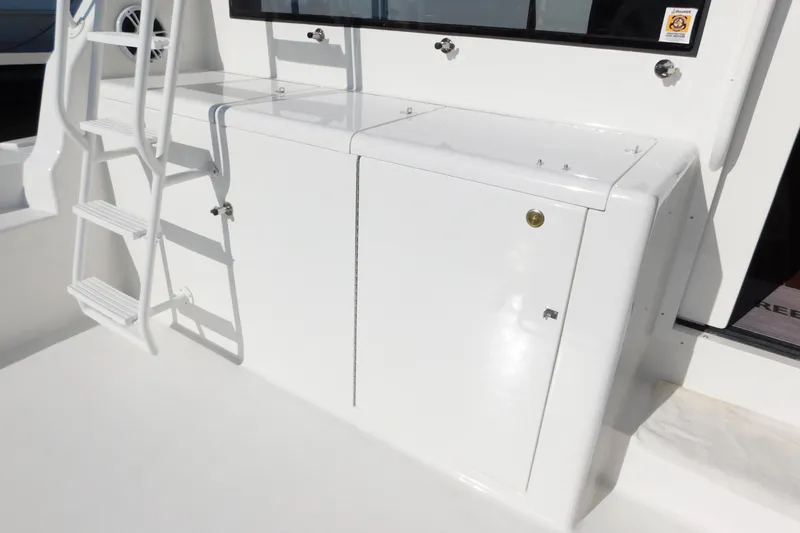 Slide: The Image of White deck area of a 1996 Viking 50 Convertible yacht with ladder and storage compartments. - 21