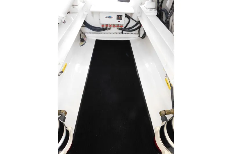 Slide: The Image of Engine room of 1996 Viking 50 Convertible yacht, featuring clean white surfaces and equipment. - 62