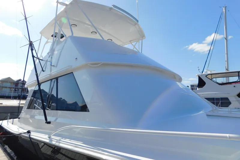 Slide: The Image of 1996 Viking 50 Convertible yacht docked under clear blue sky. - 10