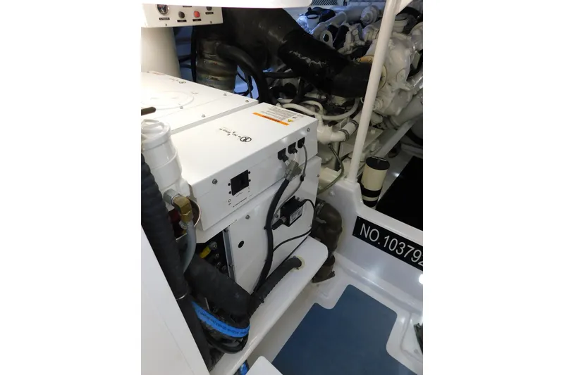 Slide: The Image of Engine room of 1996 Viking 50 Convertible yacht, showcasing mechanical components and wiring. - 67