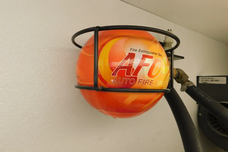 Slide: The Image of Fire extinguisher ball on 1996 Viking 50 Convertible yacht, mounted in metal bracket. - 77