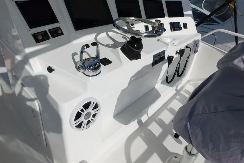 Slide: The Image of Control panel of a 1996 Viking 50 Convertible yacht with steering wheel and instruments. - 12