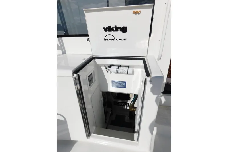 Slide: The Image of 1996 Viking 50 Convertible yacht hatch labeled "Man Cave" with interior view. - 57