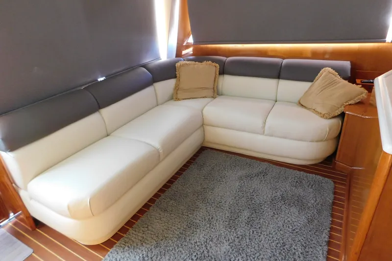 Slide: The Image of Luxurious interior of 1996 Viking 50 Convertible yacht with plush seating and cozy decor. - 26