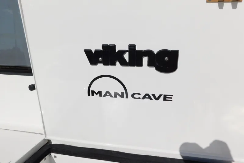 Slide: The Image of Viking 50 Convertible 1996 boat with 'Man Cave' logo on white surface. - 58