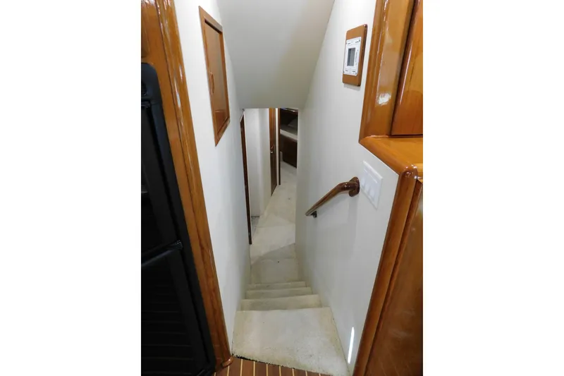 Slide: The Image of Interior staircase of 1996 Viking 50 Convertible yacht with wooden accents. - 42