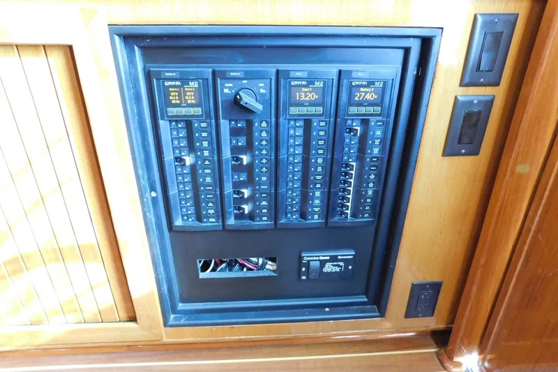 Slide: The Image of Electrical panel on a 1996 Viking 50 Convertible yacht, featuring switches and voltage displays. - 33