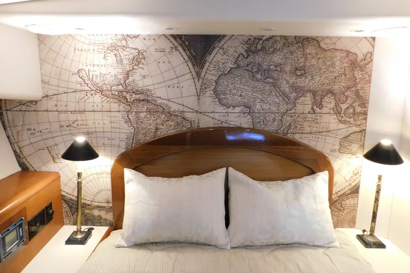 Slide: The Image of Luxurious 1996 Viking 50 Convertible yacht bedroom with vintage world map decor. - 52