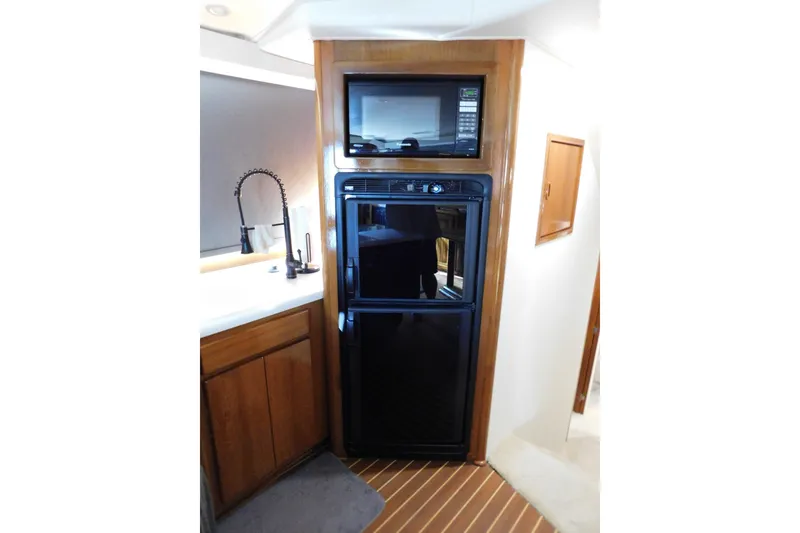 Slide: The Image of Interior of 1996 Viking 50 Convertible yacht with microwave and refrigerator. - 36