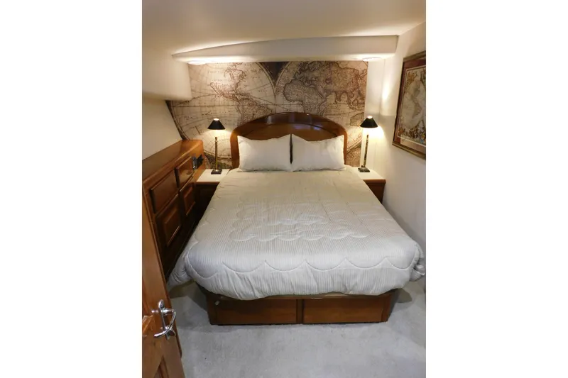 Slide: The Image of Cozy bedroom in 1996 Viking 50 Convertible yacht with map-themed decor and elegant lighting. - 50