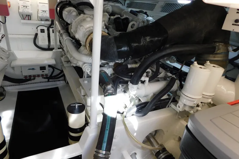 Slide: The Image of Engine room of a 1996 Viking 50 Convertible yacht, showcasing mechanical components. - 63