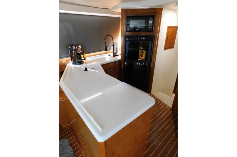 Slide: The Image of Interior of 1996 Viking 50 Convertible yacht kitchen with modern appliances and sleek countertops. - 35