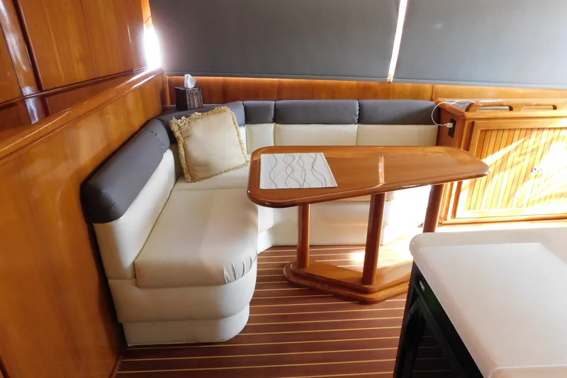 Slide: The Image of Luxurious interior of 1996 Viking 50 Convertible yacht with elegant seating and wooden table. - 27
