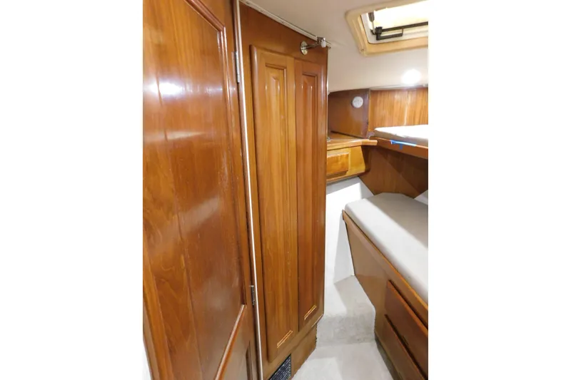 Slide: The Image of Interior of 1996 Viking 50 Convertible yacht with wooden cabinetry and cozy sleeping area. - 45