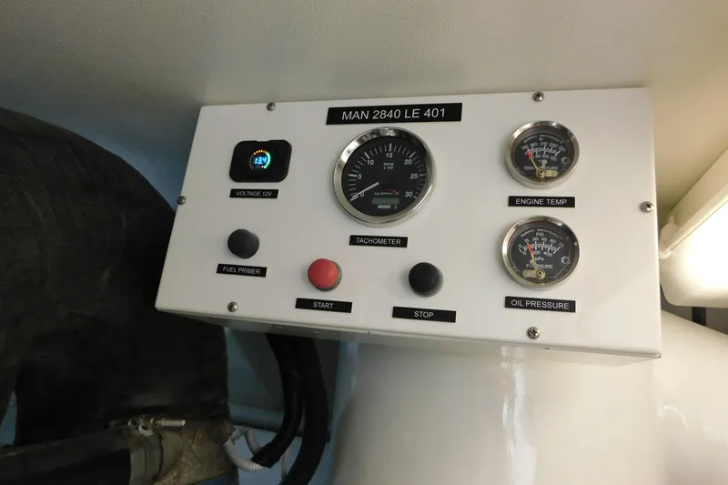 Slide: The Image of Engine control panel of a 1996 Viking 50 Convertible boat, featuring gauges and switches. - 70