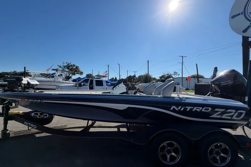 Slide: The Image of 2024 Nitro Z20 boat on trailer under clear blue sky. - 9