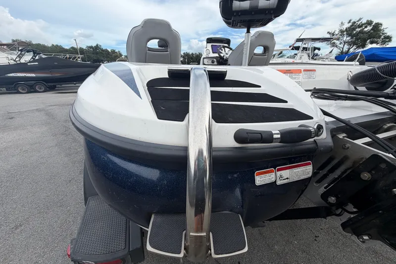 Slide: The Image of 2024 Nitro Z20 boat rear view with ladder and seating, parked on concrete. - 81