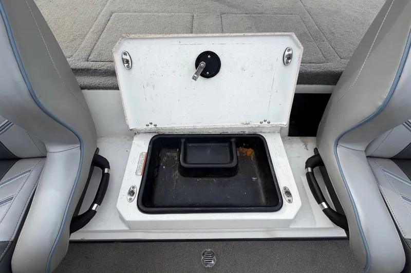 Slide: The Image of Open storage compartment in 2024 Nitro Z20 boat, between two seats. - 61