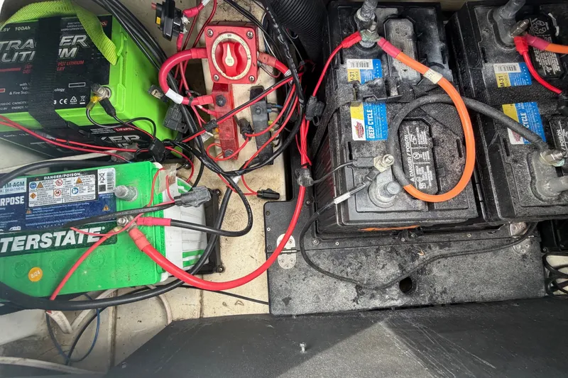 Slide: The Image of Battery compartment of a 2024 Nitro Z20 boat with wiring and connections. - 76